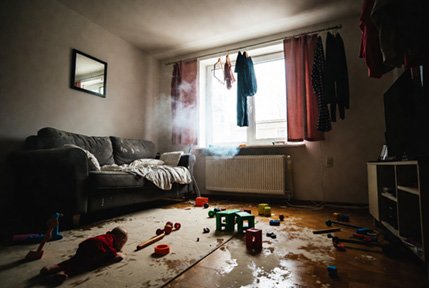 Dirty living room filled with toys and clutter, showing lingering thirdhand smoke residue and chemicals in a home environment after smoking has occurred